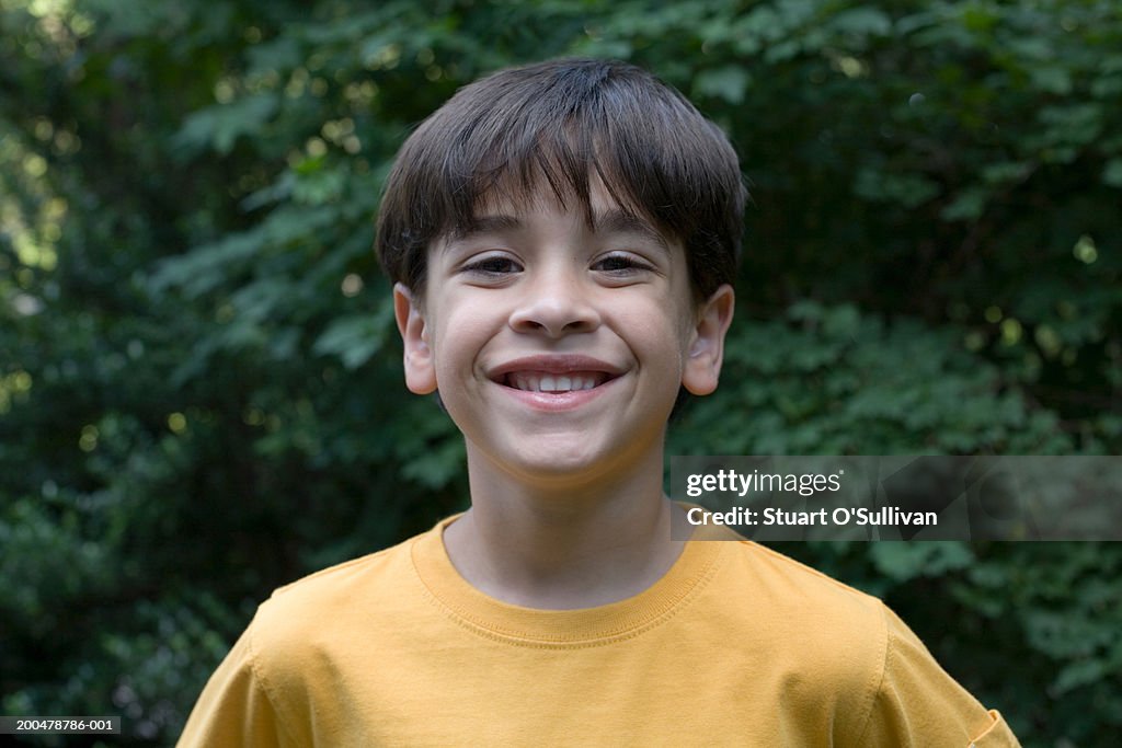 Boy (6-8) smiling, portrait