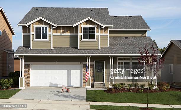 exterior of house, tricycle in driveway - american flag house stock pictures, royalty-free photos & images