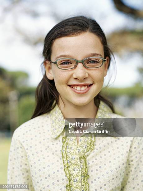 Teenage Girl Standing In Field Smiling Portrait High-Res Stock