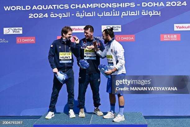 Gold medallist Great Britain's Aidan Heslop , silver medallist France's Gary Hunt and bronze medallist Romania's Catalin-Petru Preda pose during the...