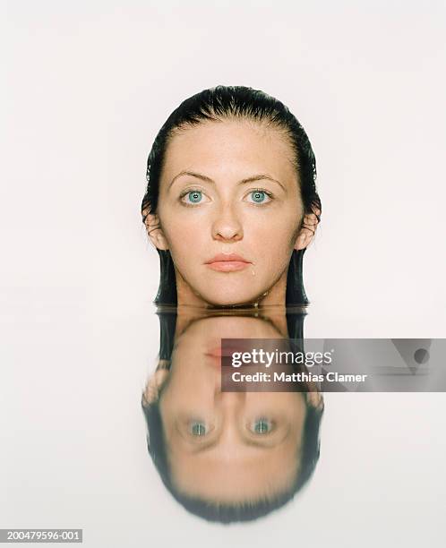 young woman with face above water - symmetry people stock pictures, royalty-free photos & images