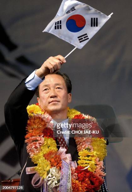 South Korean soccer supremo and independent presidential candidate Chung Mong-Joon waves a small national flag during the launching of his new party,...