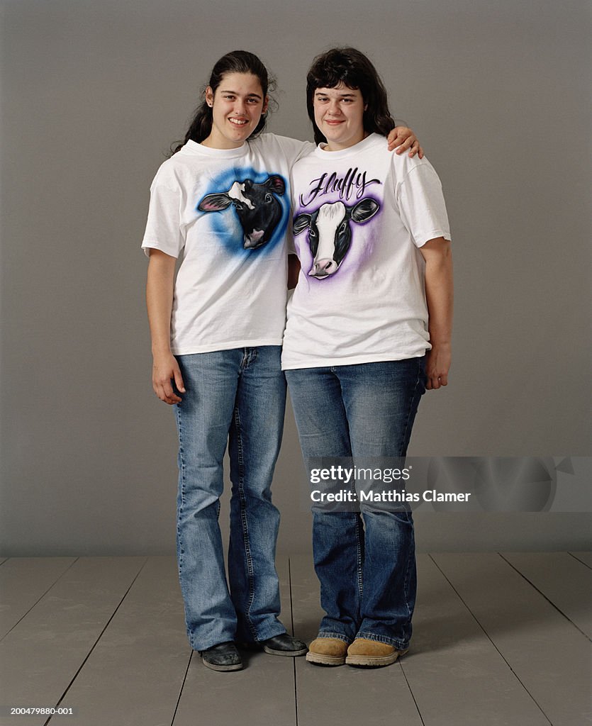 Teenage sisters (17-20) with airbrushed tee shirts, portrait