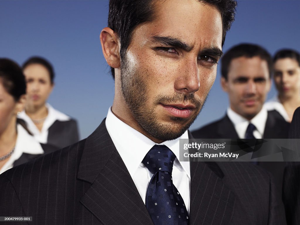 Business executives outdoors, man in foreground