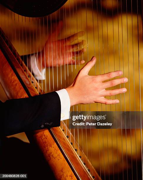 man playing harp, close-up of hands - classical musician - fotografias e filmes do acervo