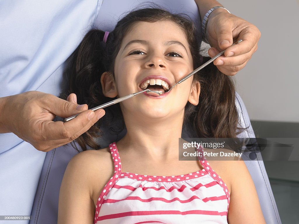 Dentist examining girl (7-9)