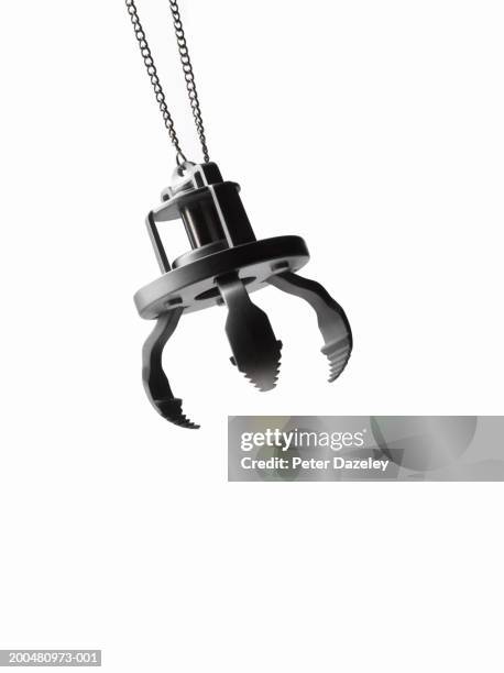 toy grabber, against white background, close-up - benna meccanica foto e immagini stock