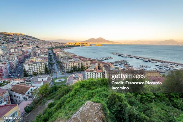 naples, campania, italy. cityscape from posillipo, vesuvius volcano on background and sea bay in a sunny day. - baia foto e immagini stock