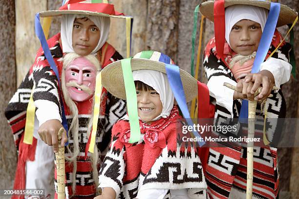 children wearing traditional costume and hats - mask culture stock-fotos und bilder