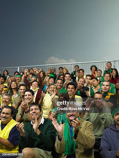 crowd applauding in stands - crowd applauding stock pictures, royalty-free photos & images