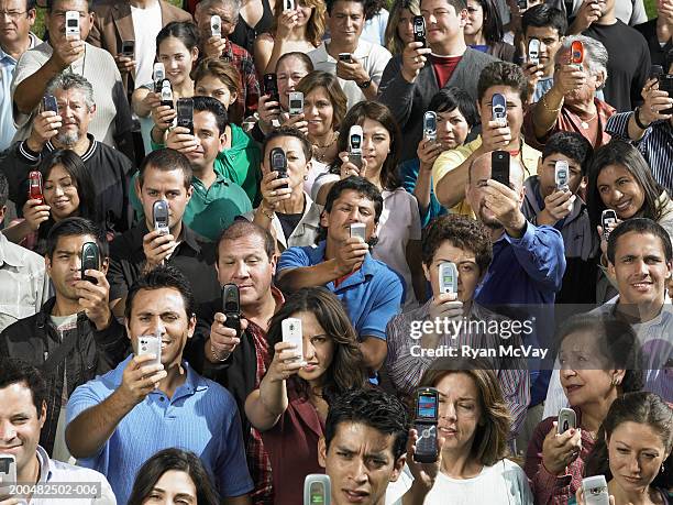 Man Using Many Phones 2,197 Crowd Of People Holding Phones Stock Photos, High-Res Pictures ...