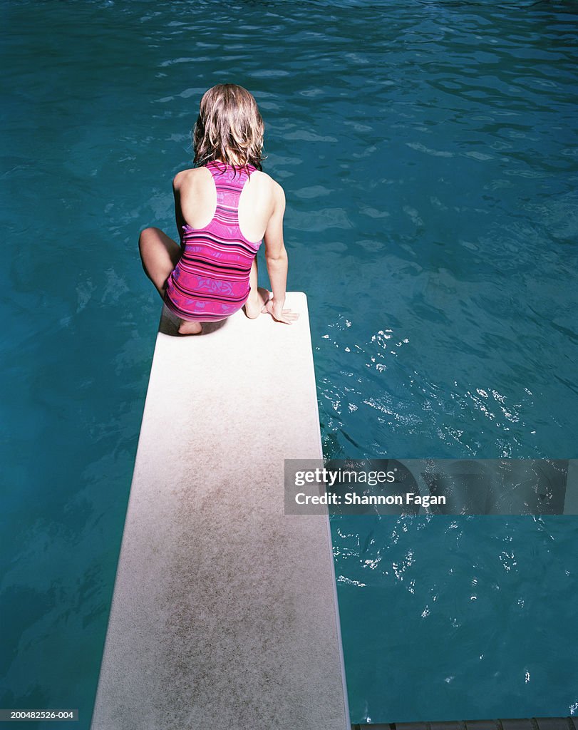 Pool Crounching Girl Crouching On Diving Board At Swimming Pool High-Res Stock Photo ...