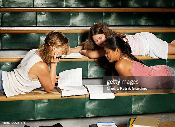 teenage girls (12-14) doing homework in gym - girl who stands stock pictures, royalty-free photos & images