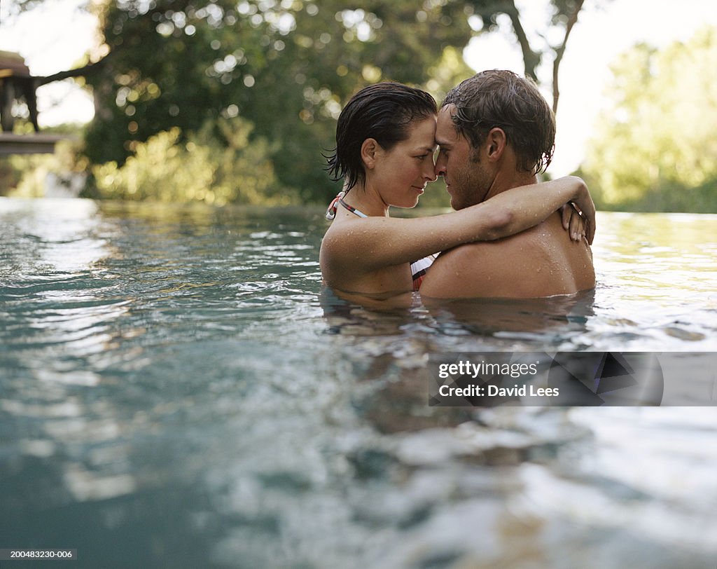 Young couple embracing in water