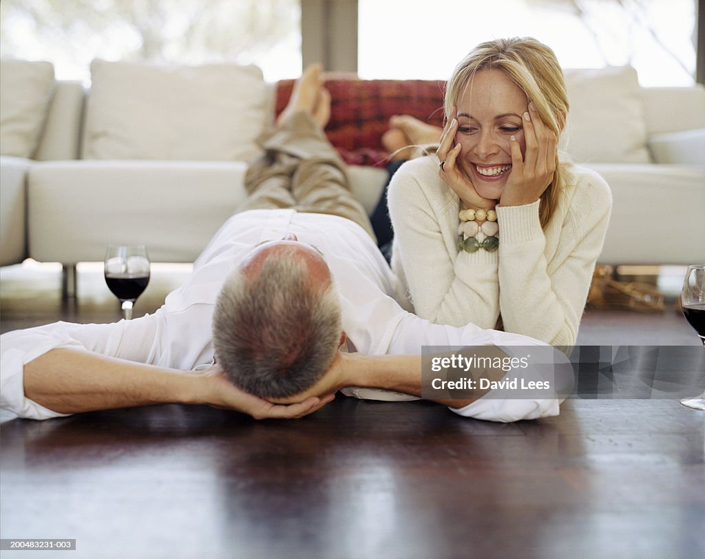 Couple lying on floor in living room