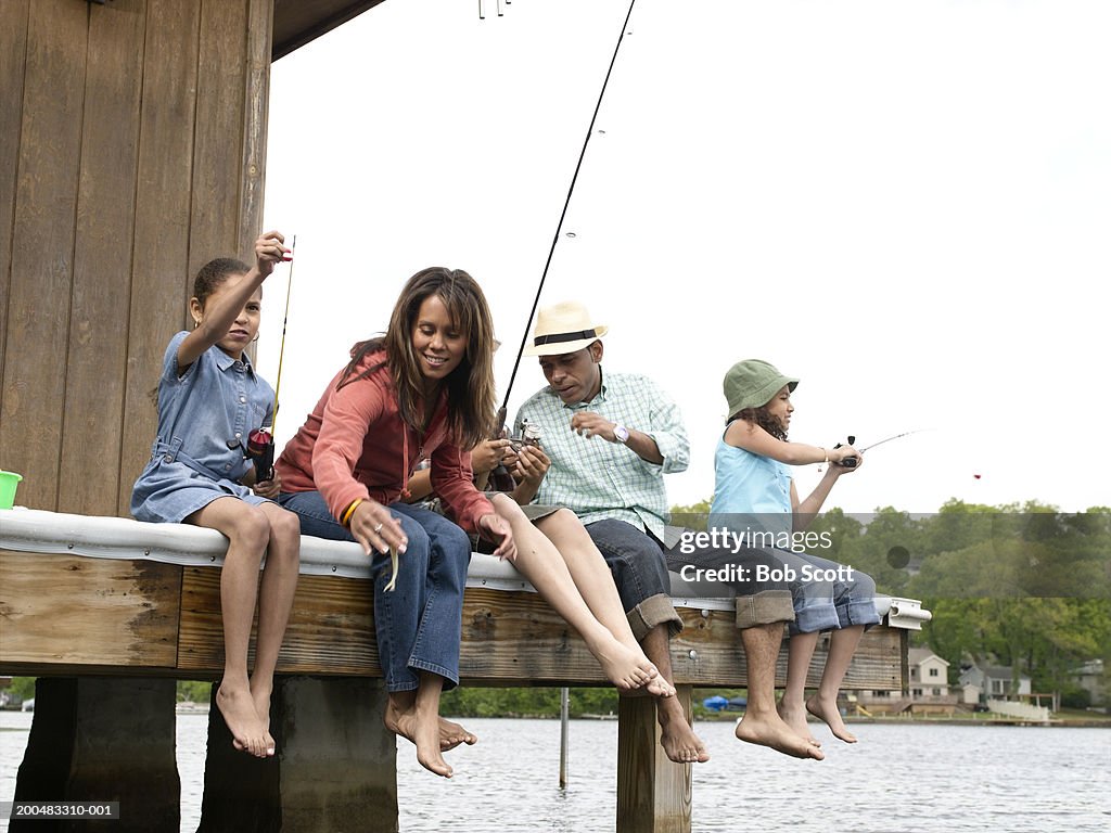 Parents and daughters (8-10) fishing from dock