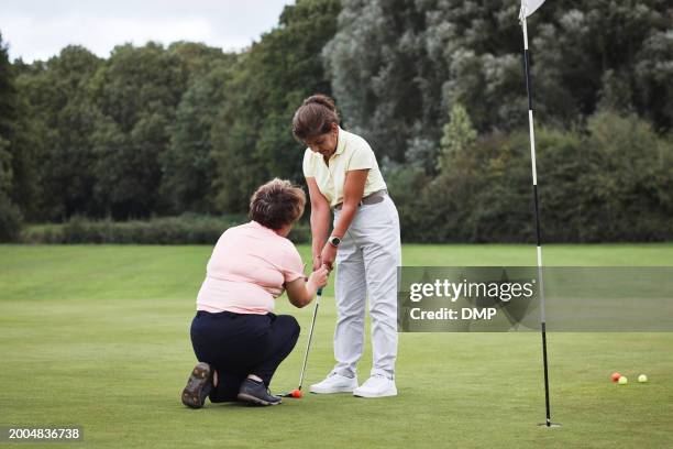 golf, sports and mature women learn on field, fitness and training for game with coach, help and support outdoor. personal trainer, teaching and exercise, athlete practice and instruction on turf - trust exercise stock pictures, royalty-free photos & images