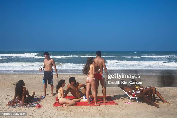 young people relaxing at beach - head back stock pictures, royalty-free photos & images
