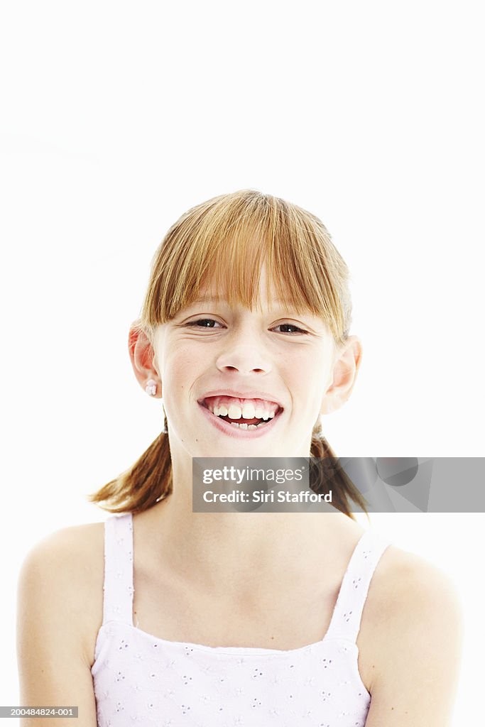 Girl (10-12) smiling, portrait