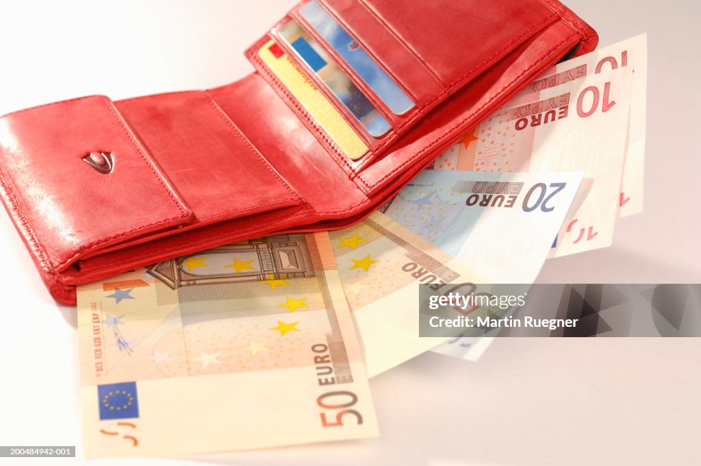 Euro banknotes in red purse