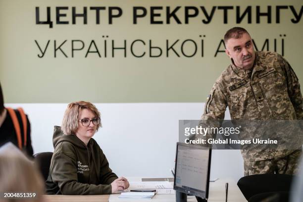 Worker of the recruiting centre of Ukrainian Army speaks to a serviceman during the opening of the centre on February 12, 2024 in Lviv, Ukraine....