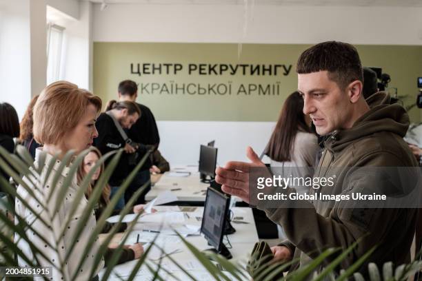 Worker of the recruiting centre of Ukrainian Army speaks to a serviceman during the opening of the centre on February 12, 2024 in Lviv, Ukraine....