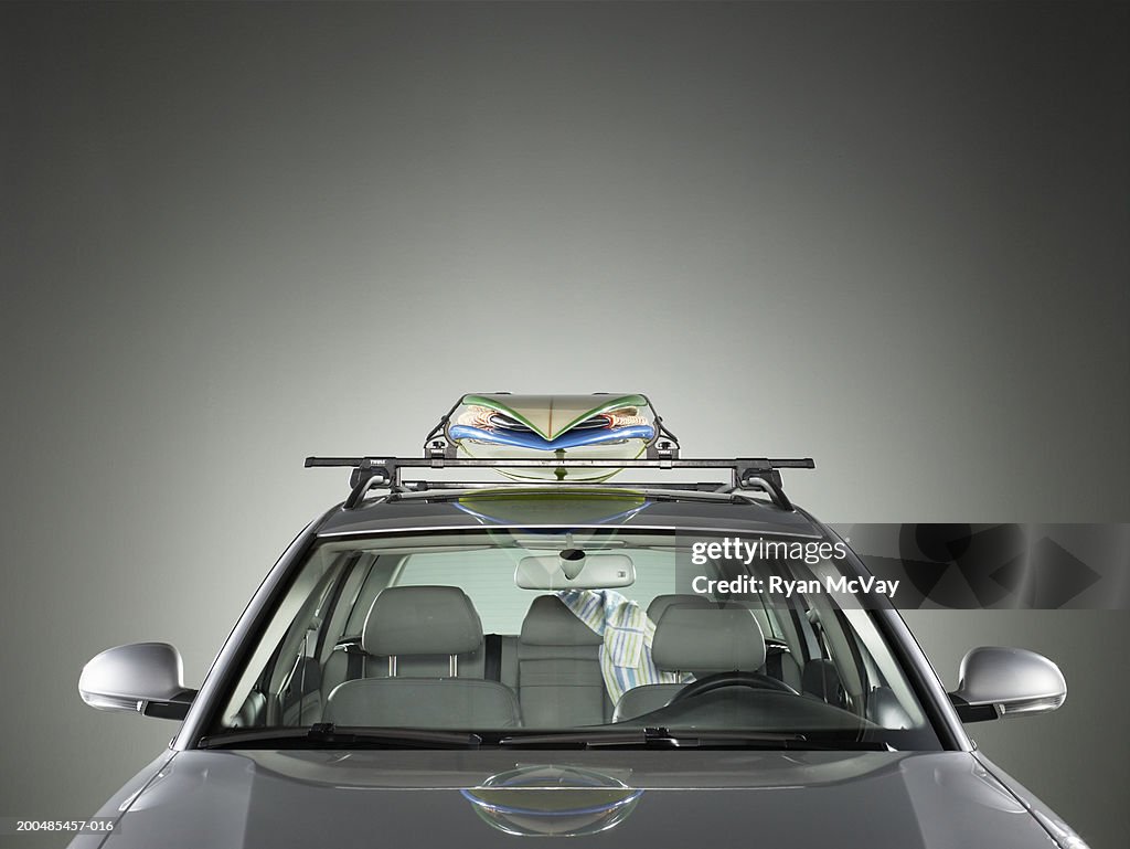 Surfboards strapped to roof of car