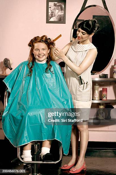 girl (10-12) having hair styled in beauty salon - vintage beauty salon stock-fotos und bilder