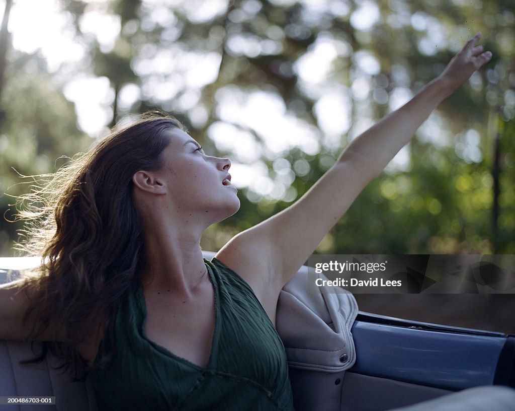 Young woman in convertible car