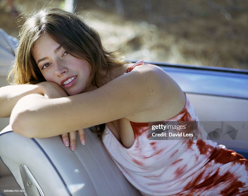 Young woman in convertible car, portrait