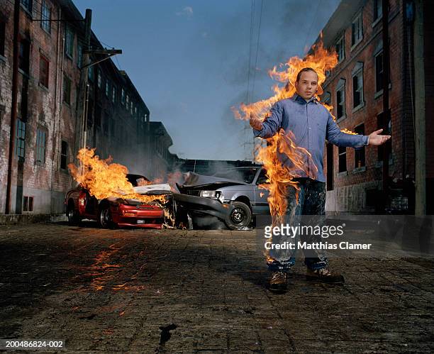 man on fire, car collision in background - vancouver people stock pictures, royalty-free photos & images
