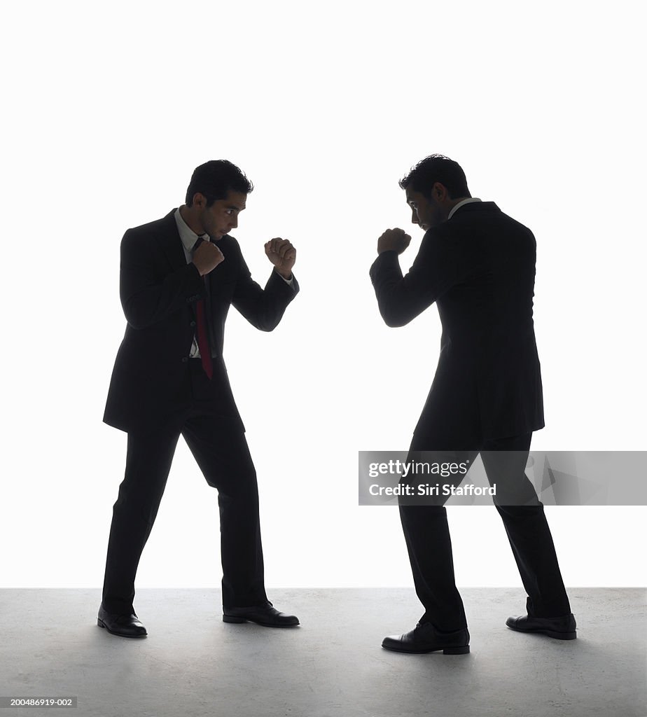 Businessman boxing with himself