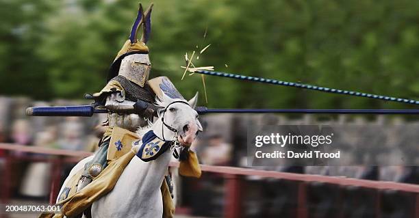 man participating in jousting tournament, lance impacting on shield - traditional helmet stock pictures, royalty-free photos & images