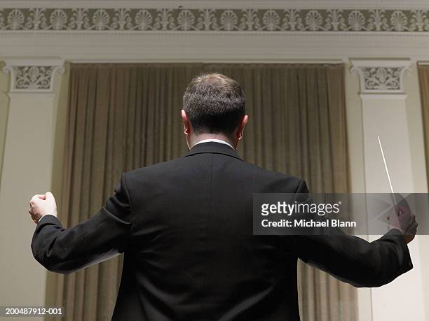 conductor with baton, rear view - classical stock photos et images de collection