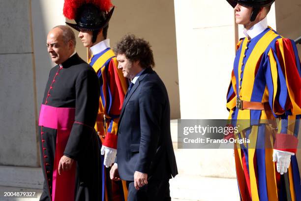 Argentina's President Javier Milei, flanked by Monsignor Guillermo Karcher, leaves the Apostolic Palace after an audience with Pope Francis on...