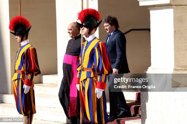 Argentina's President Javier Milei , flanked by Monsignor Guillermo Karcher, leaves the Apostolic Palace after an audience with Pope Francis on...