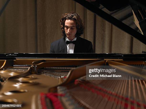 concert pianist playing grand piano - piano stock pictures, royalty-free photos & images