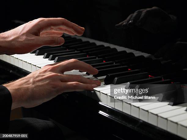 male pianist playing piano, close-up - tasteninstrument stock-fotos und bilder