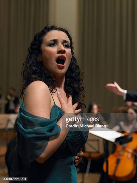 female singer performing with orchestra - orchestra rehearsal stock pictures, royalty-free photos & images