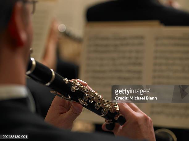 male clarinetist performing in orchestra, close-up, rear view - klarinett bildbanksfoton och bilder