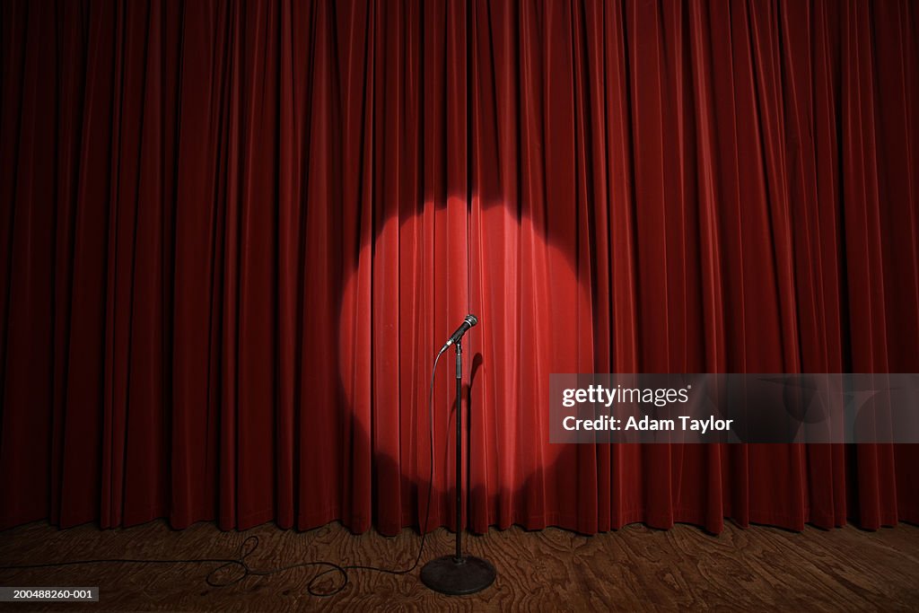 Spotlight on microphone stand on stage