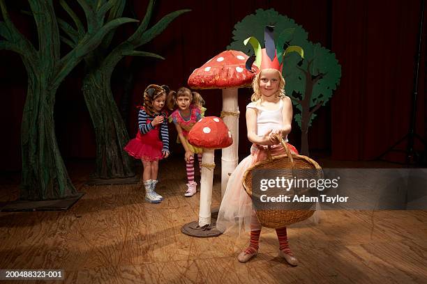 children (5-7) acting on stage, one girl holding basket, portrait - stage seven stock pictures, royalty-free photos & images