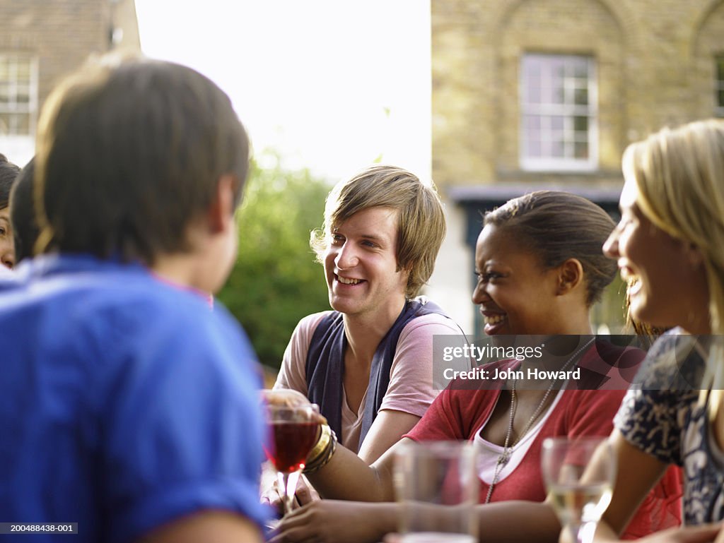 Group of young people at pub table, outdoors