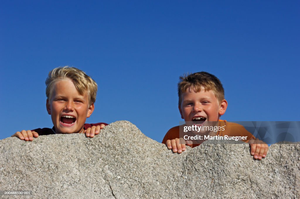 Two Laughing Rocks Two Boys Laughing Behind Rock Portrait High-Res Stock Photo - Getty Images