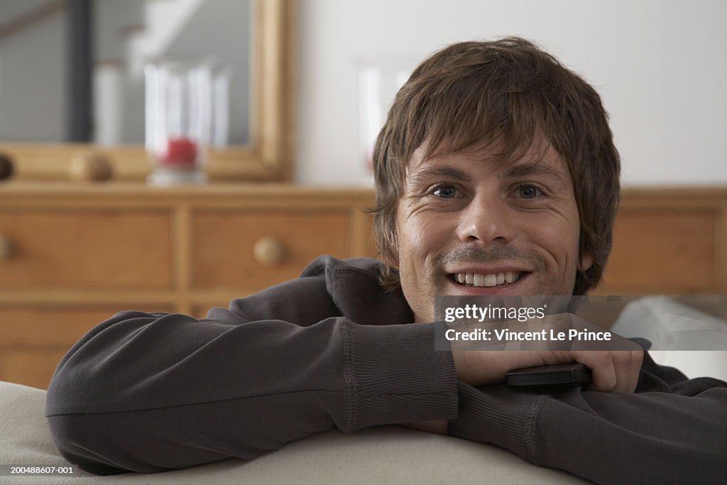 Young man on sofa, close-up, portrait