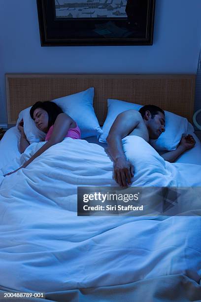 couple sleeping in bed - lying on side stock pictures, royalty-free photos & images