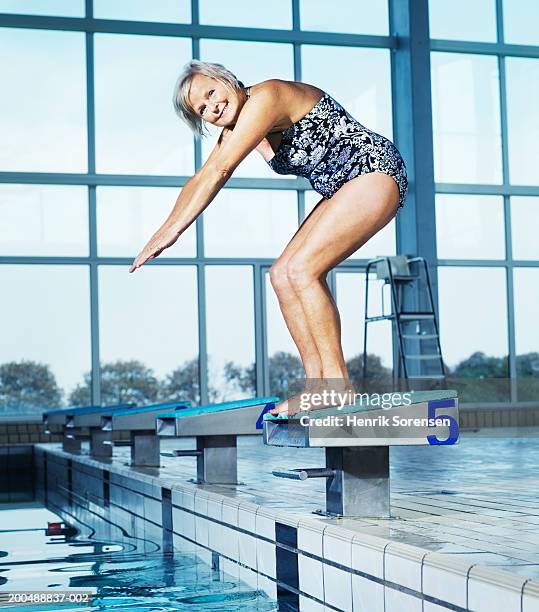 mature woman on diving board at swimming pool, portrait - old people diving stock pictures, royalty-free photos & images