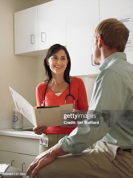 female doctor talking to male patient - doctor cropped stock pictures, royalty-free photos & images