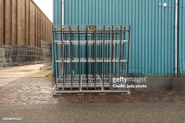 steel racks are outside on the street - industrial storage bins stock pictures, royalty-free photos & images