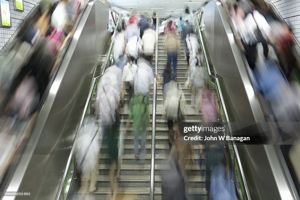 China, Shanghai, commuters on escalator at underground railway station